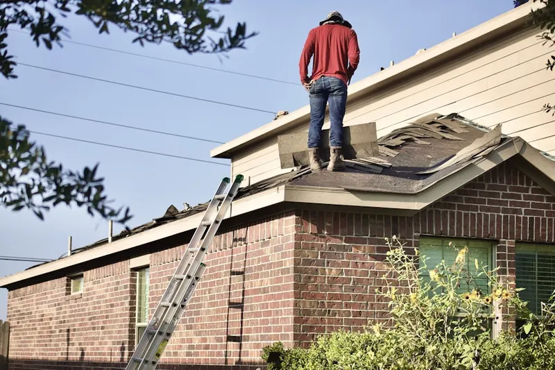 Professional roofer working on a residential roof in Brentwood Estates